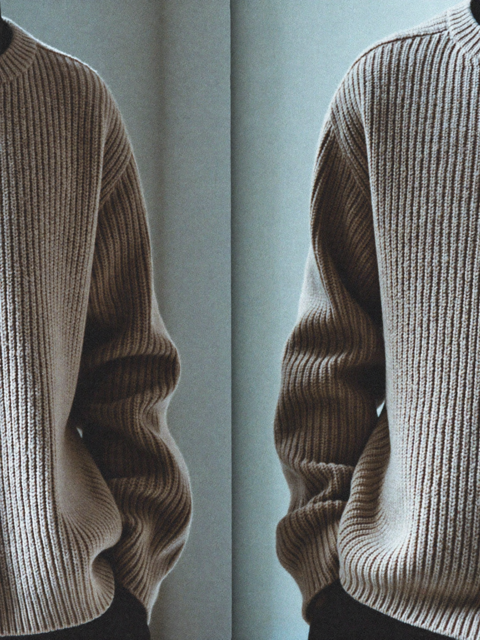 Detail of a heavy oatmeal ribbed wool jumper in cool daylight